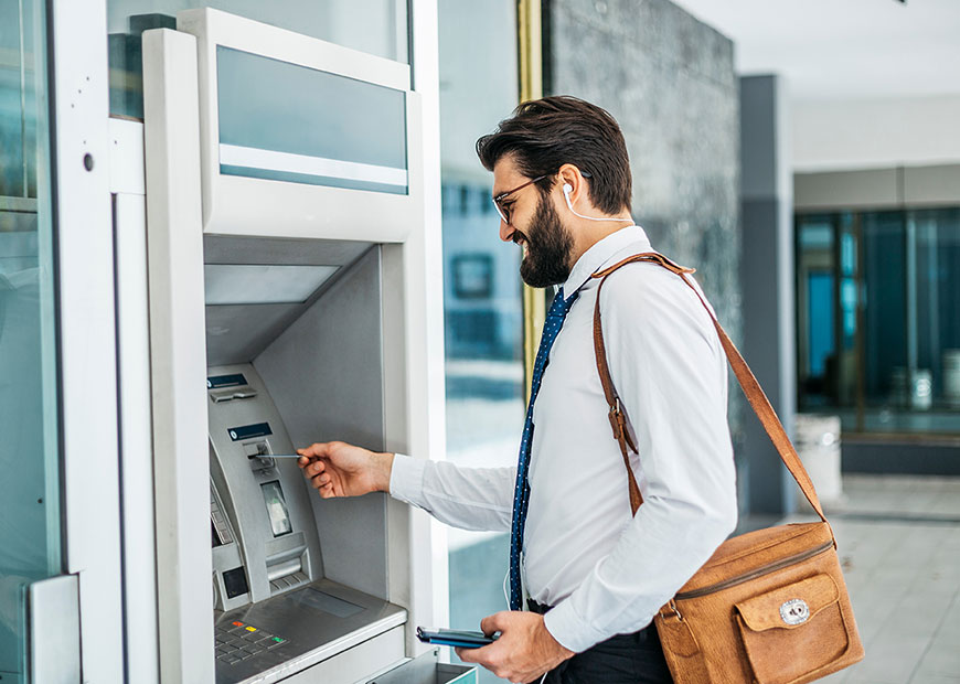 image of man using ATM