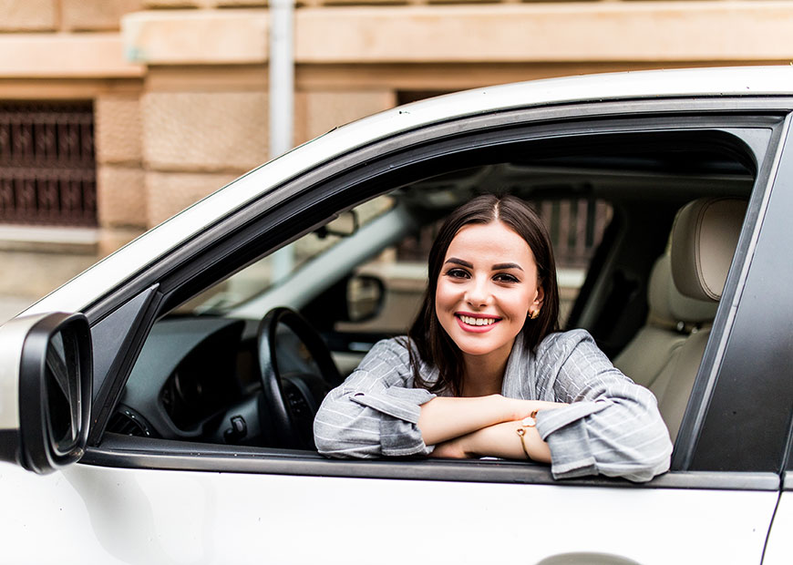 image of smiling woman in car