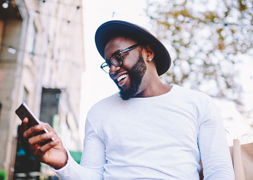 image of smiling man looking at phone