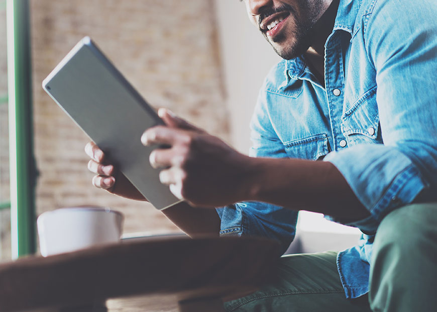 image of man holding tablet