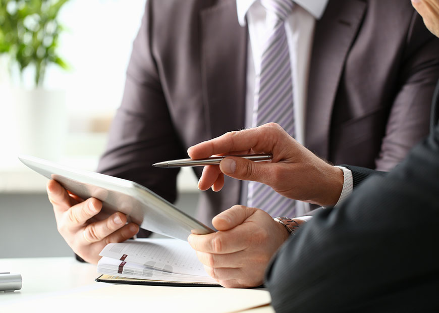 image of two business people looking at tablet