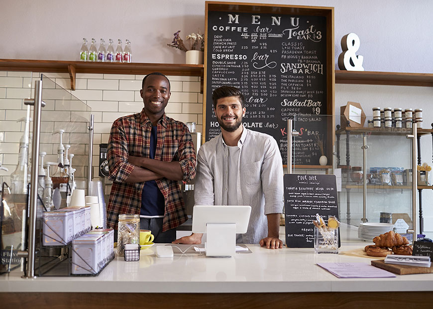 image of two men behind counter at a coffee bar