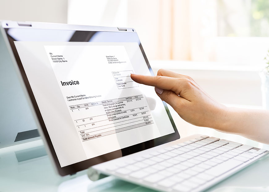 image of person looking at invoice on a computer monitor
