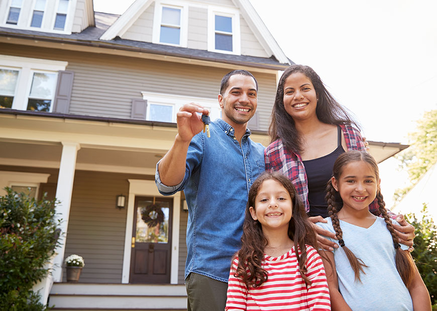 image of family holding key outside new home