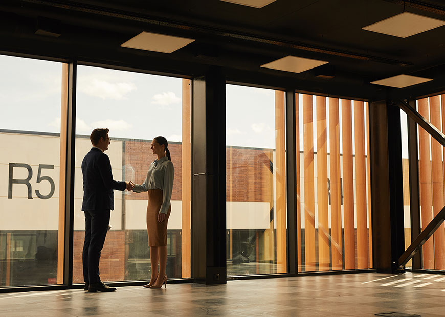 image of two people shaking hands in office