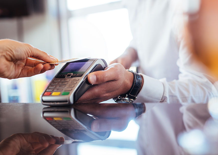image of person using debit card at card reader