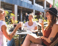 image of group of women drinking coffee outdoors