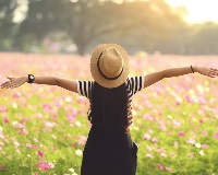 image of girl standing in field of flowers