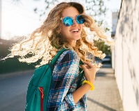 image of young girl smiling with backpack