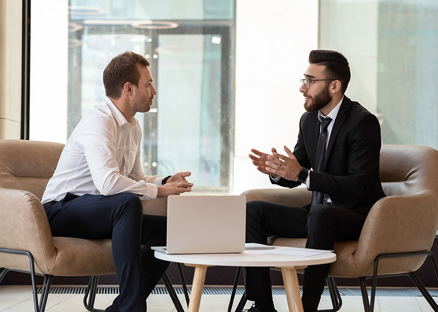 image of two men having conversation