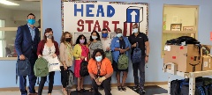image of School Ready Day event with employees in front of Head Start background
